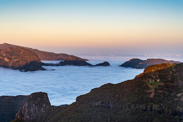 Mist with highest part of hills above in Madeira during sunset - view from Bica da Cana hill
