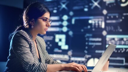 Smart Arabic woman working with laptop in digital center, portrait of female programmer writes code