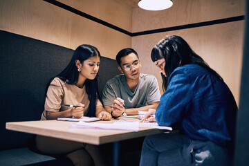 Business people, teamwork or discussion in cafe for remote work with planning, paperwork or serious...