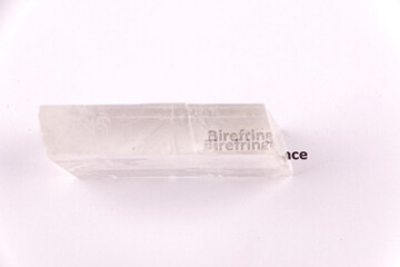 Optical birefringence demonstrated using a text using a natural double spar / calcite crystal