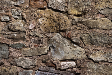 in the photo there is a close-up of an old stone wall