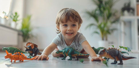 happy child playing with dinosaur toys on the floor