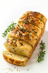 Freshly baked loaf of bread with aromatic herbs on a white plate. Suitable for food blogs or bakery advertisements