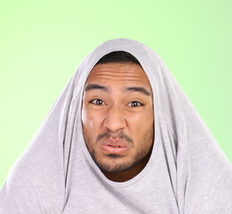Man, portrait and silly face with disgust for funny smell, self esteem or ego on a green studio...