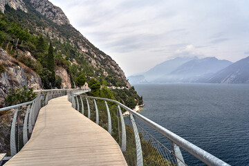 a path for pedestrians and cyclists hanging on rugged rocks on Lake Garda