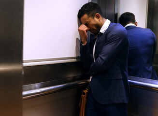 Stress, depression or man cry in elevator for business fail, bankruptcy or recession disaster....