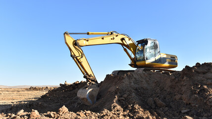 Excavator on earthmoving. Open-pit mining. Backhoe dig ground in quarry. Heavy construction...
