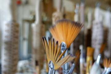 a set of painting brushes and some wooden structure rollers