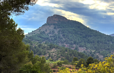Mountains landscape. View on Mola De Segart mountain in Sierra Calderona Natural park in Valencia, Spain. Clouds over mountains. Hills landscape. Landscape of a mountain valley. Road in mountains.