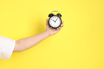 holding a clock