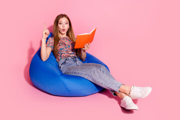 Full length photo of lovely teen lady sit bean bag read book eureka dressed stylish print clothes...
