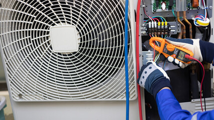 Close up Air conditioner's technician hand check  electrical circuit and maintenance condensor...