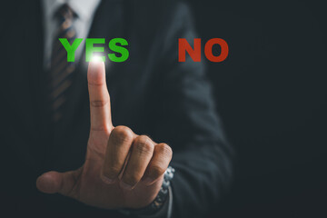 Close-up of a businessman finger pressing the Yes button, signifying decisive action and choice affirmation. Technology and decision-making concept. Think With Yes Or No Choice. - obrazy, fototapety, plakaty