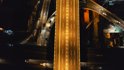 Closeup traffic road with cars, trucks drive at night top down aerial view. Philippines capital...