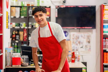 Supermarket cashier working at the register. Cash register worker standing at the counter, waiting...