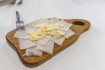 Traditional Alentejo snack chapel of bacon with garlic in a rustic Alentejo restaurant.