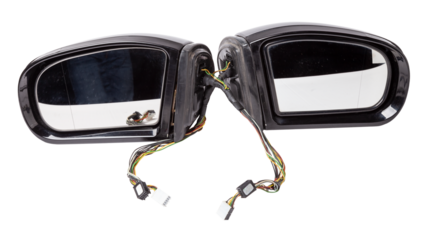 Close-up on a pair of side mirrors from a minibus with turn signal repeaters for repair and replacement after an accident in a workshop. Auto service industry. Spare parts catalog.