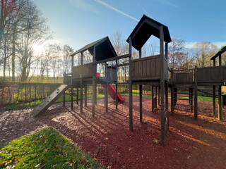 Colorful playground with climbing stairs and slides on yard in the park.  - obrazy, fototapety, plakaty