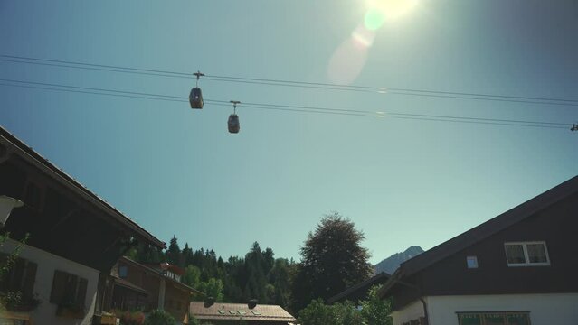 Nebelhornbahn. Allgau, Oberstdorf, Germany. Cable car to the high mountain in Bavaria in city of Oberstdorf. Gondola cabins move on sunny day in Bavarian alps. Bergbahn am Nebelhorn. 
