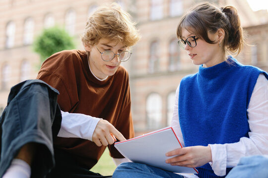 Pair students doing homework tasks educational subjects