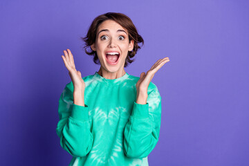 Photo portrait of attractive young woman raise shocked excited dressed stylish green clothes isolated on violet color background