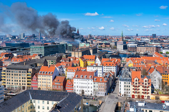 Black smoke drifts over central Copenhagen as historic Copenhagen Stock Exchange goes up in flames. Denmark