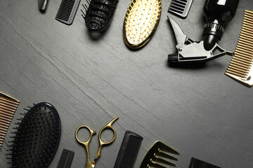 Hairdressing tools on grey textured background, flat lay. Space for text