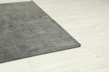 Fototapeta premium Soft grey carpet on white laminated floor indoors