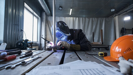 manual welding of metal with plasma in production