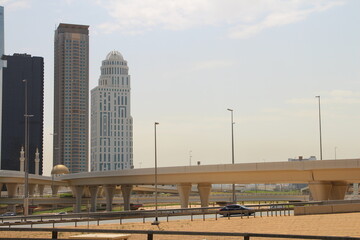 A bridge over a river with buildings in the background