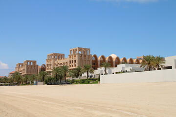 A large building with a sandy area