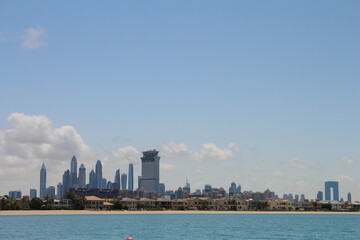 Obraz premium City skyline with a river and blue sky with clouds
