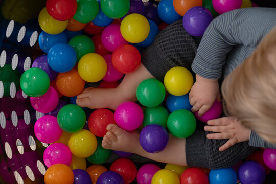 Toddler playing in homemade ball pit.