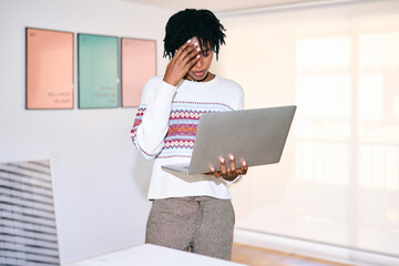 Strained busineswoman using laptop