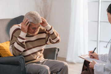 Prioritizing Mental Health: Asian Seniors Receive Expert Care at Hospital Clinics, Consultations with Professional Practitioners Ensuring Comprehensive Diagnosis and Treatment Coverage - obrazy, fototapety, plakaty