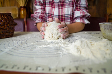 child with dough in the kitchen, girl sculpting, helping mom, rolling out dough, preparing food, rural interior, boho kitchen, atmospheric photos with a child in the kitchen