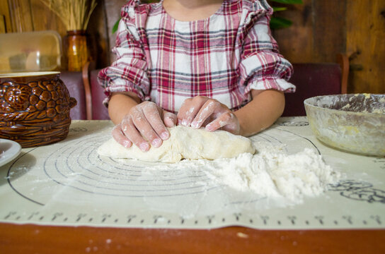 child with dough in the kitchen, girl sculpting, helping mom, rolling out dough, preparing food, rural interior, boho kitchen, atmospheric photos with a child in the kitchen