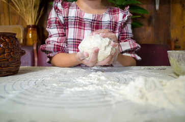 child with dough in the kitchen, girl sculpting, helping mom, rolling out dough, preparing food, rural interior, boho kitchen, atmospheric photos with a child in the kitchen