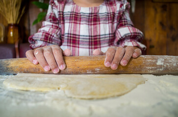 child with dough in the kitchen, girl sculpting, helping mom, rolling out dough, preparing food, rural interior, boho kitchen, atmospheric photos with a child in the kitchen
