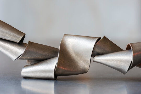 Steel flat bar, abstract curves and waves on metal surface, industry raw material