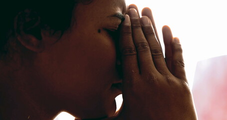 Young woman suffering from depression covers face feeling upset and regretful. Profile close-up of person feeling stress and pressure