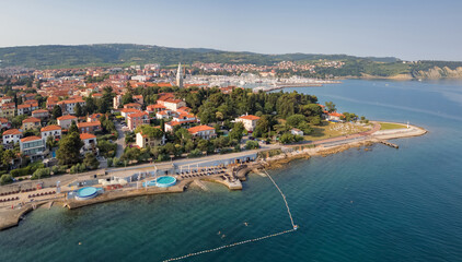 Stunning old town Izola in Slovenia at sunset, a picturesque Mediterranean settlement, aerial shot. Vacation, travel, and tourism concepts.