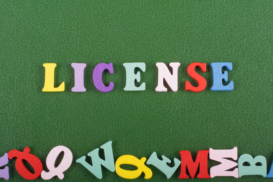 LICENSE word on green background composed from colorful abc alphabet block wooden letters, copy space for ad text. Learning english concept.