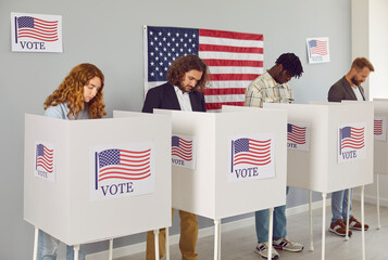 Portrait of a group of young happy diverse American citizens people men and women standing at vote...