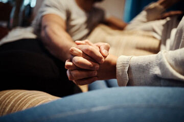 Holding hands, couple and love on couch for romance, home and support or empathy in marriage....