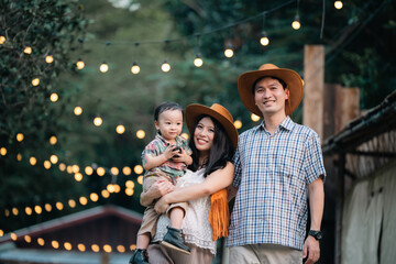 Family Fun in the Great Outdoors: Asian Parents and Cheerful Children Enjoying Summer Camping Vacation, A Happy Day of Leisure and Nature Exploration, Creating Memorable Outdoor Adventures Together