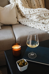 Wine and olives on the coffee table, romantic cozy atmosphere