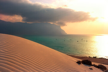 sand dune with a relief pattern of sand and a view of the emerald ocean. Paradise Island,