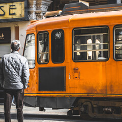Old orange tram in the historic city center of Turin, Italy