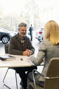 Smiling customer finalizes deal unrecognized dealer